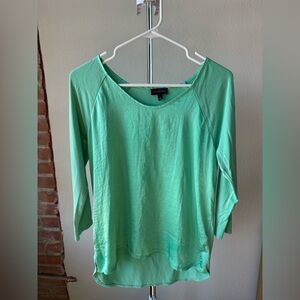 The limited , metallic green top